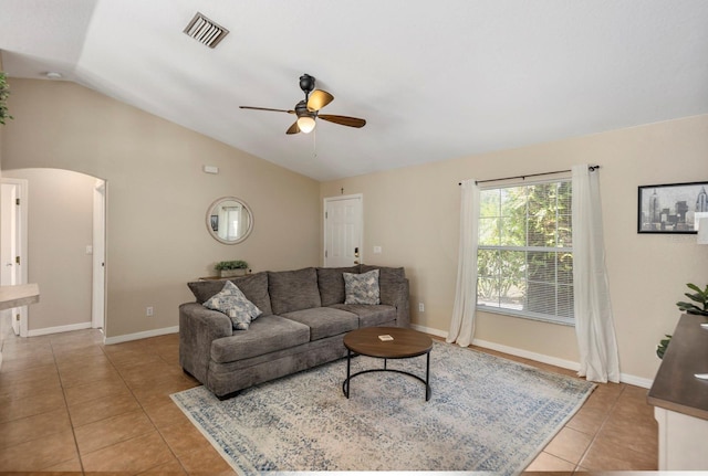 tiled living room featuring ceiling fan and lofted ceiling