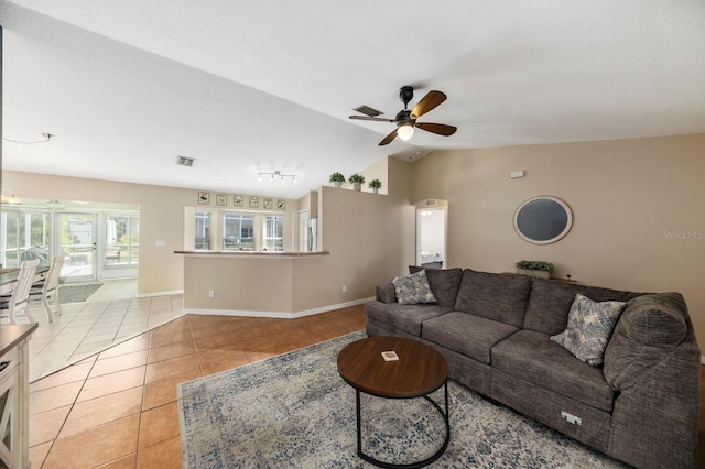 living room with vaulted ceiling, ceiling fan, and light tile patterned flooring