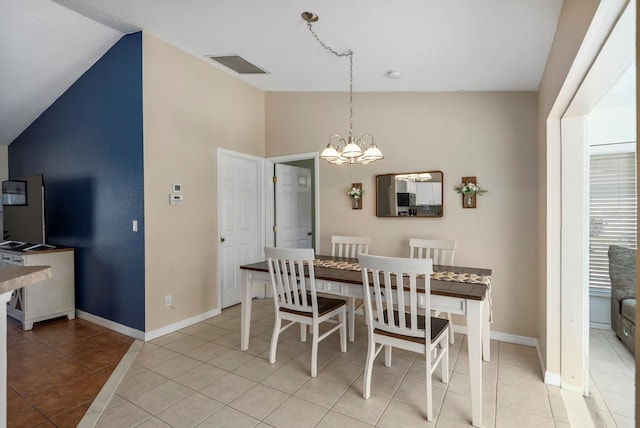 tiled dining room featuring vaulted ceiling and a notable chandelier