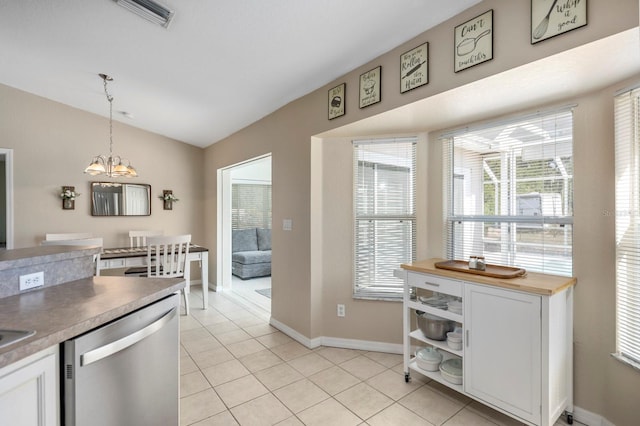 kitchen featuring stainless steel dishwasher, decorative light fixtures, a healthy amount of sunlight, and white cabinetry