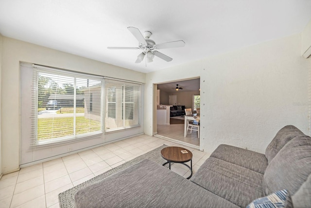 living room with ceiling fan and light tile patterned flooring