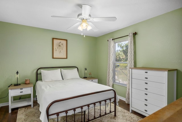 bedroom with ceiling fan and dark wood-type flooring