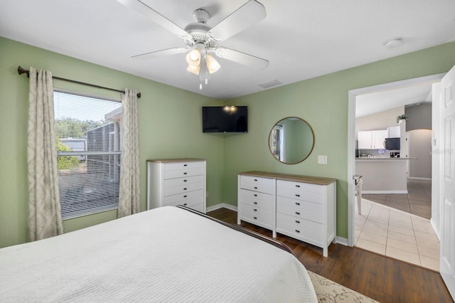 bedroom with dark hardwood / wood-style floors, ceiling fan, and lofted ceiling