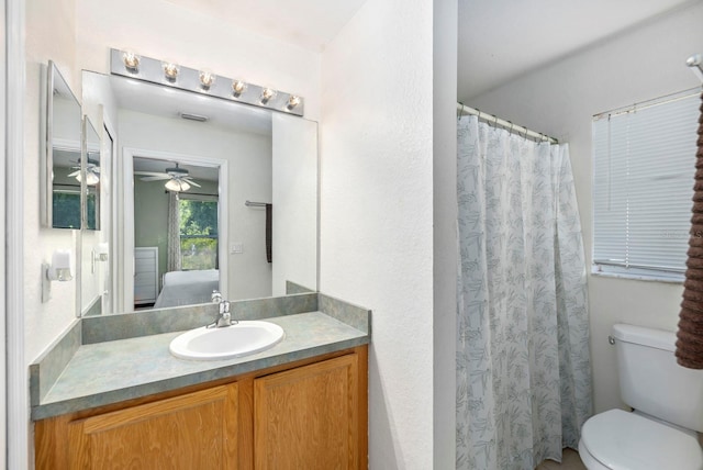 bathroom featuring vanity, ceiling fan, and toilet