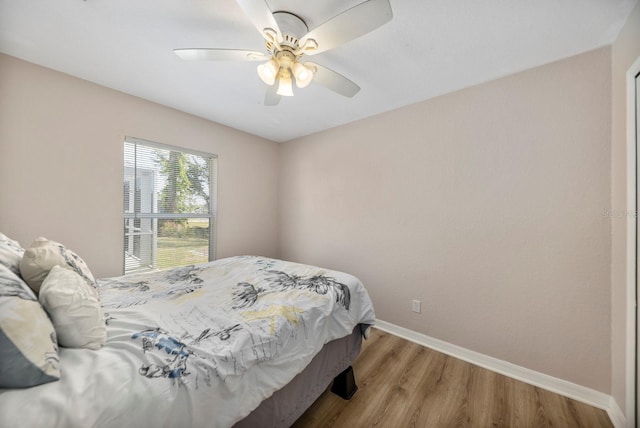 bedroom with light hardwood / wood-style floors and ceiling fan