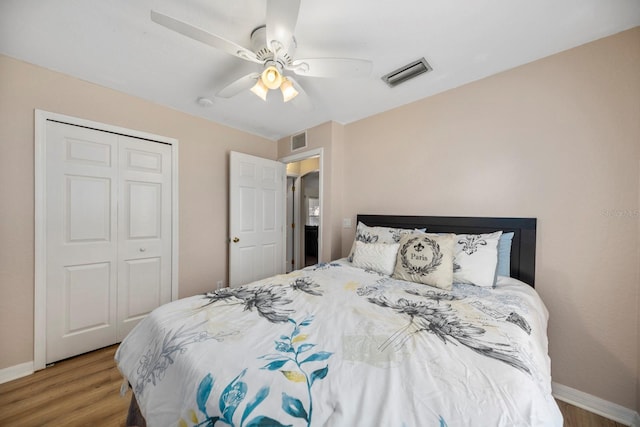 bedroom with light wood-type flooring, a closet, and ceiling fan