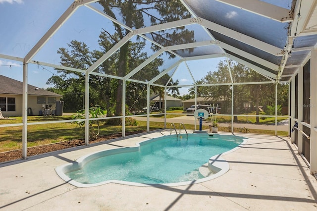 view of pool featuring glass enclosure, a patio area, and a yard