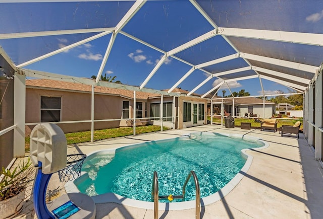 view of swimming pool featuring a patio and glass enclosure