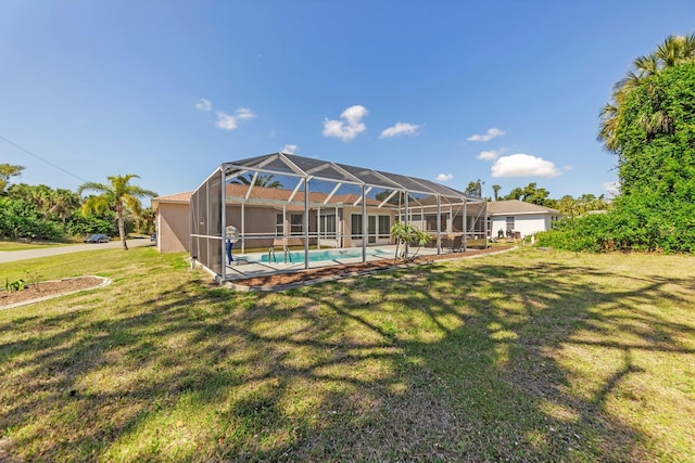 rear view of house with a lawn and glass enclosure