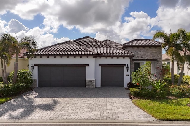 mediterranean / spanish house with a garage