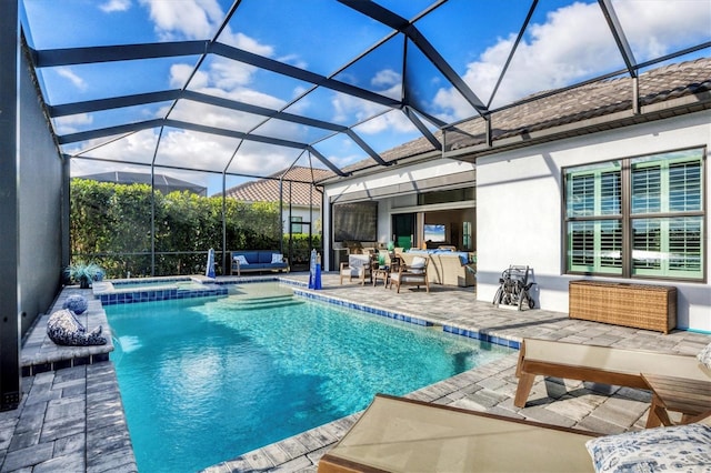 view of swimming pool with outdoor lounge area, glass enclosure, a patio area, and an in ground hot tub