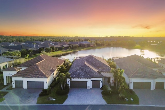 aerial view at dusk with a water view