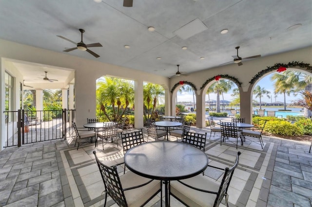 view of patio / terrace with a water view and ceiling fan