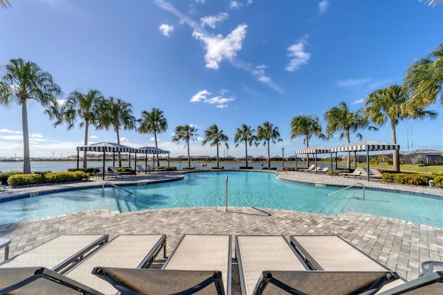 view of swimming pool with a gazebo, a patio area, and a water view