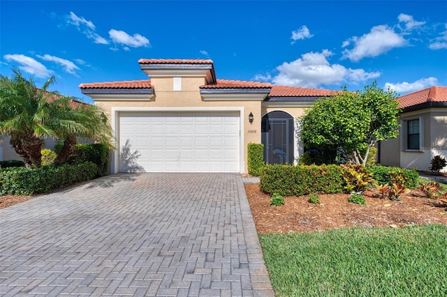 mediterranean / spanish home featuring a garage