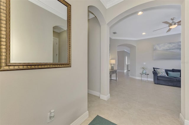 hallway with light tile patterned floors and crown molding