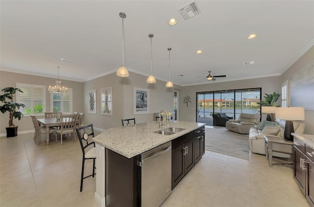 kitchen featuring sink, stainless steel dishwasher, a kitchen island with sink, ceiling fan with notable chandelier, and ornamental molding