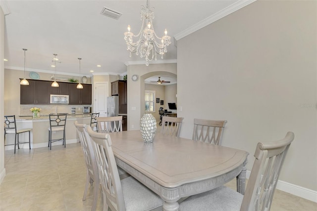 tiled dining area featuring ceiling fan with notable chandelier and ornamental molding