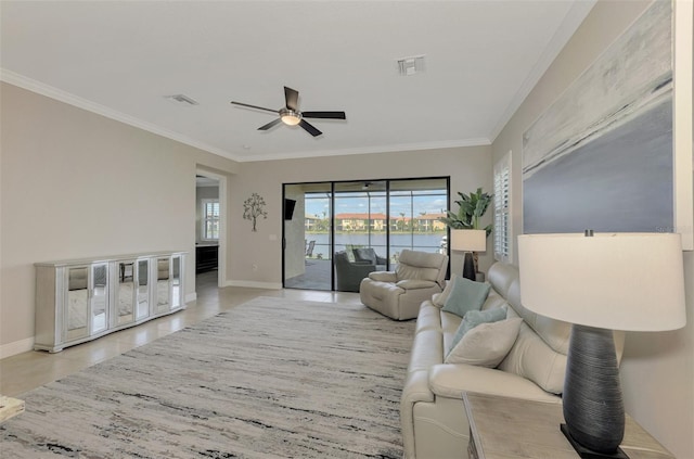 tiled living room featuring ceiling fan and crown molding