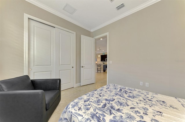 bedroom featuring crown molding, a closet, and light tile patterned floors