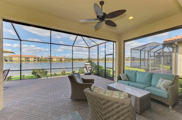 view of patio / terrace featuring an outdoor living space, a water view, ceiling fan, and a lanai