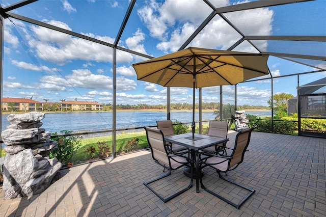 view of patio / terrace with a water view and glass enclosure