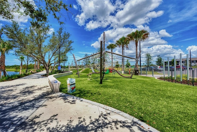 view of community featuring a water view and a lawn