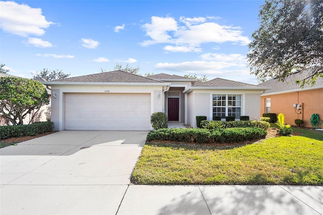 view of front of property with a garage and a front lawn