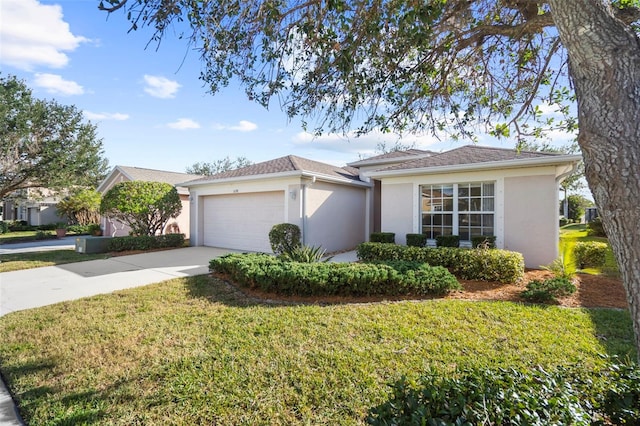 ranch-style house featuring a garage and a front lawn