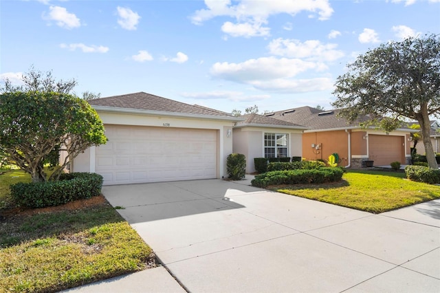 ranch-style home with a front lawn and a garage