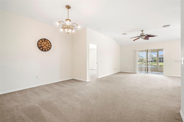 empty room featuring lofted ceiling, light colored carpet, and ceiling fan with notable chandelier