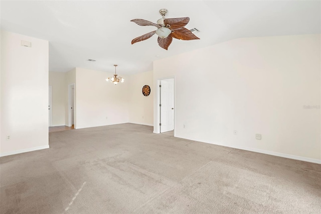 carpeted spare room featuring vaulted ceiling and ceiling fan with notable chandelier