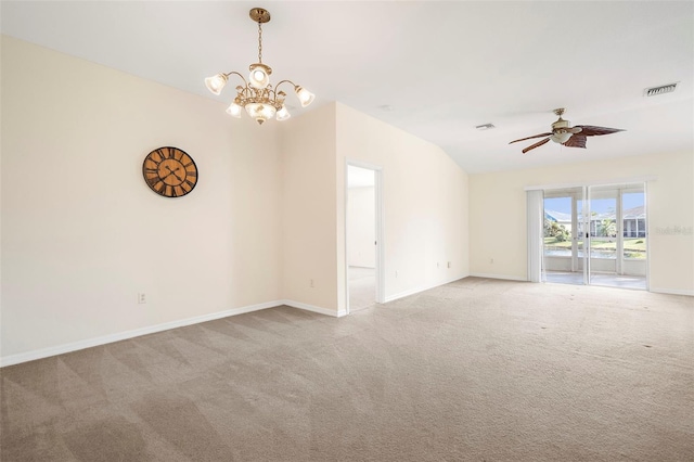 carpeted spare room with ceiling fan with notable chandelier and lofted ceiling