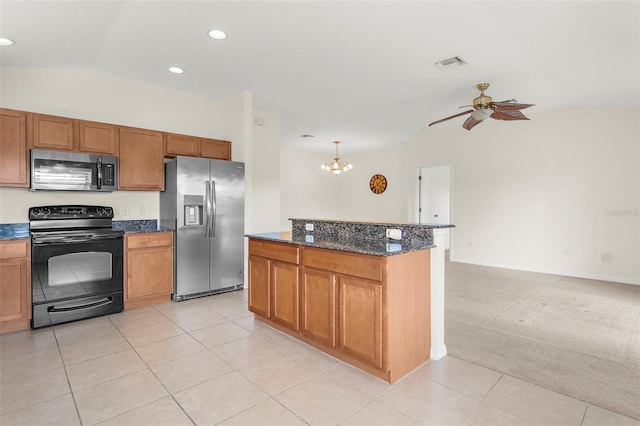 kitchen featuring dark stone countertops, lofted ceiling, light carpet, ceiling fan with notable chandelier, and appliances with stainless steel finishes