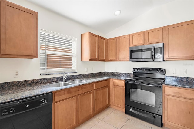 kitchen with sink, dark stone counters, lofted ceiling, light tile patterned floors, and black appliances