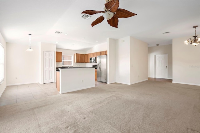 unfurnished living room with ceiling fan with notable chandelier and light colored carpet