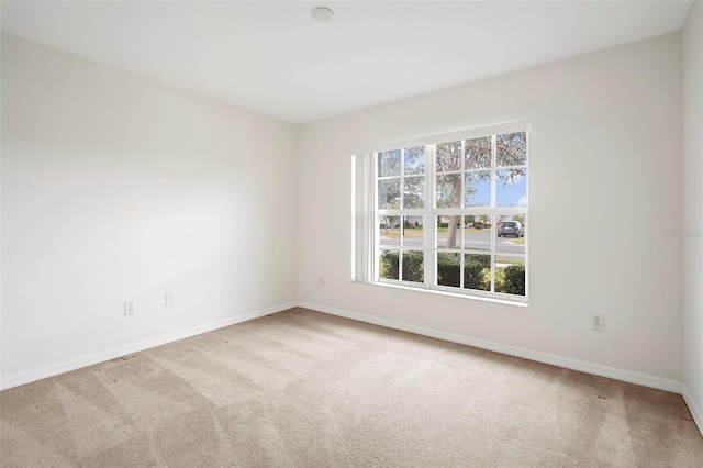 empty room featuring light colored carpet