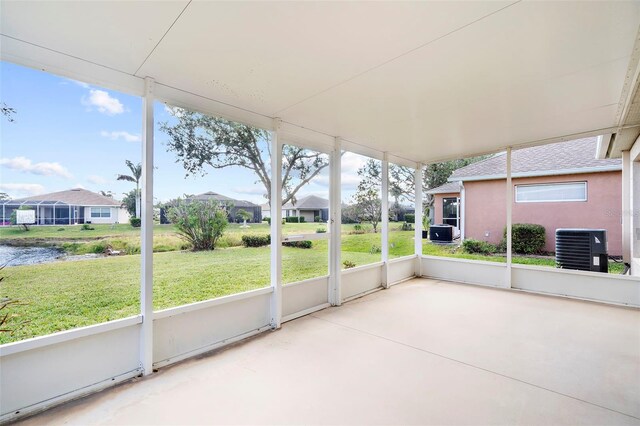 unfurnished sunroom featuring a water view