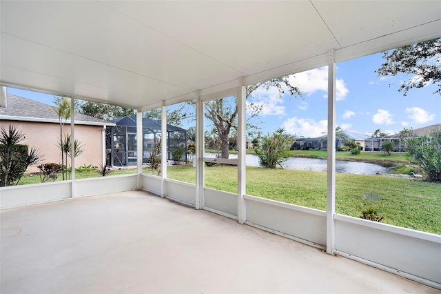 unfurnished sunroom with a water view