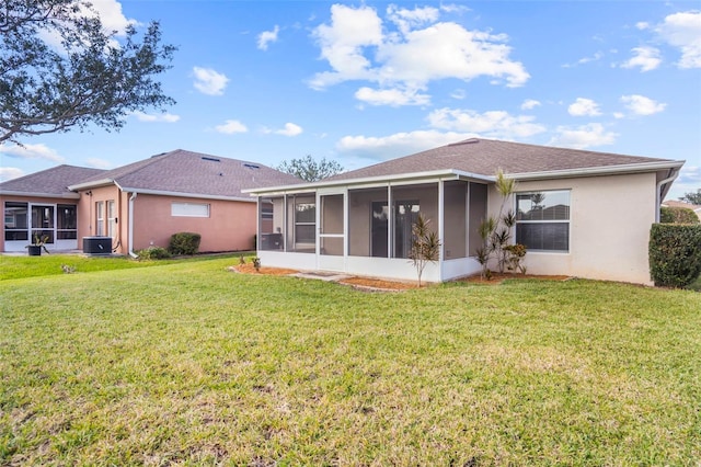 rear view of property featuring a sunroom, a yard, and cooling unit