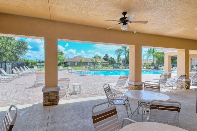 view of patio / terrace with ceiling fan and a community pool