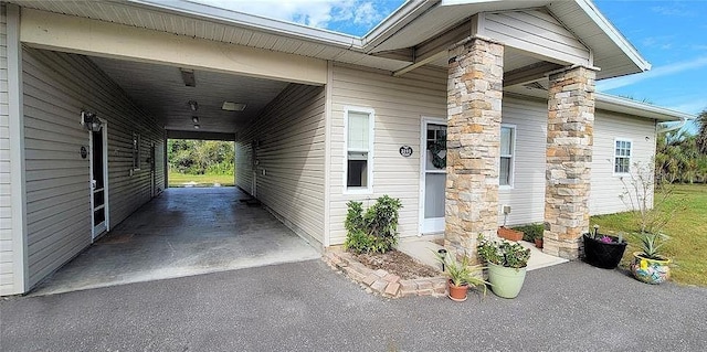 doorway to property featuring a carport