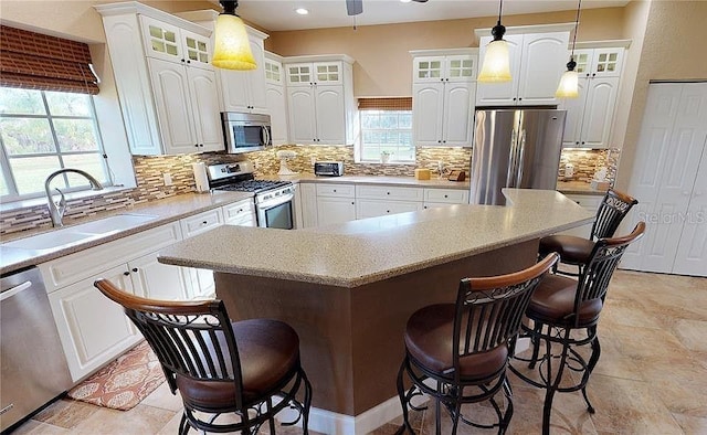 kitchen featuring white cabinets, a center island, and appliances with stainless steel finishes