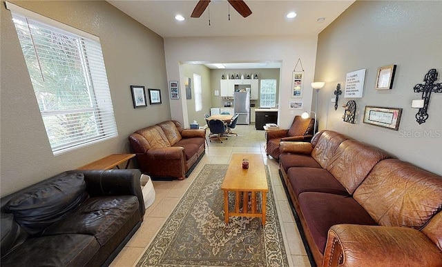 tiled living room with ceiling fan