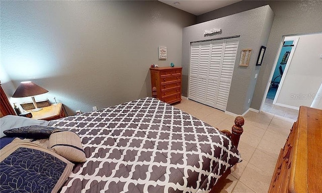 bedroom featuring light tile patterned flooring and a closet