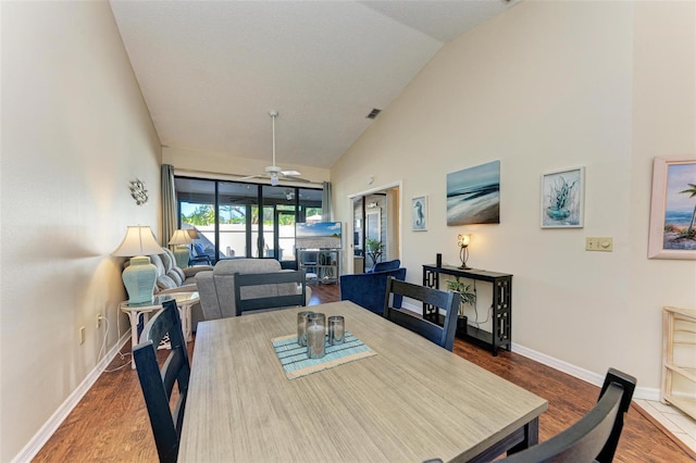 dining room featuring ceiling fan, wood-type flooring, and lofted ceiling