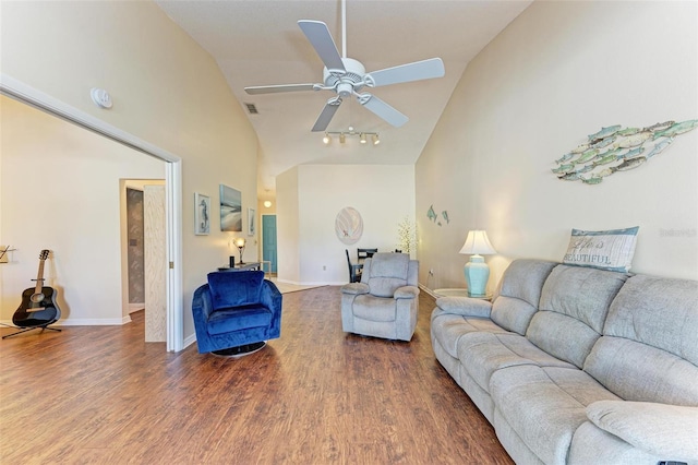 living room featuring ceiling fan, dark wood-type flooring, and high vaulted ceiling