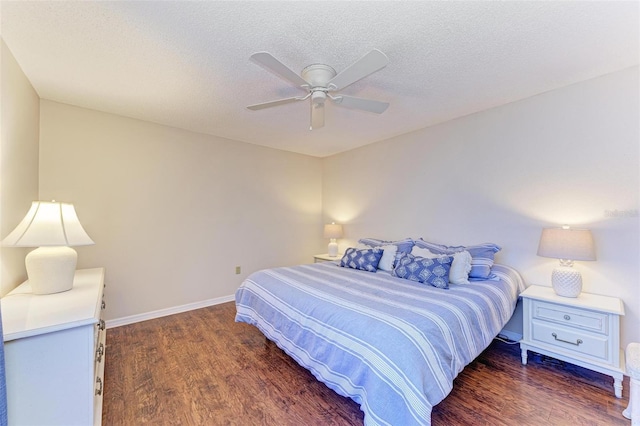 bedroom featuring a textured ceiling, dark hardwood / wood-style floors, and ceiling fan