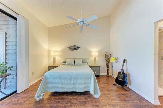 bedroom featuring access to outside, vaulted ceiling, ceiling fan, a textured ceiling, and dark hardwood / wood-style flooring