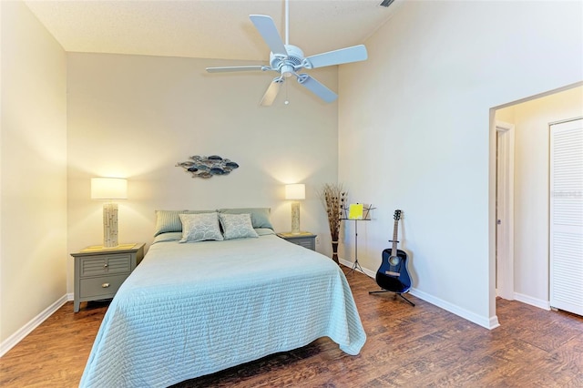 bedroom with ceiling fan, dark hardwood / wood-style flooring, and high vaulted ceiling